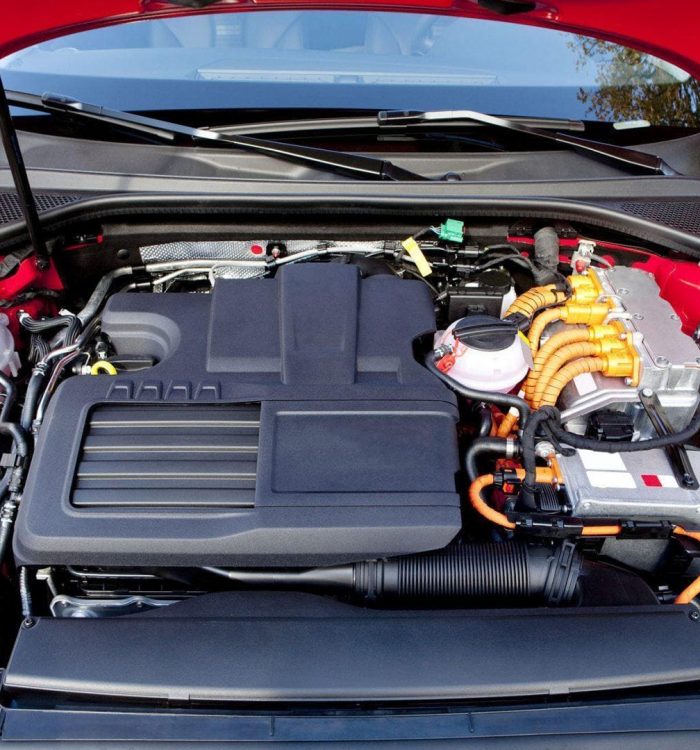 Red car engine compartment with visible engine parts and wires.